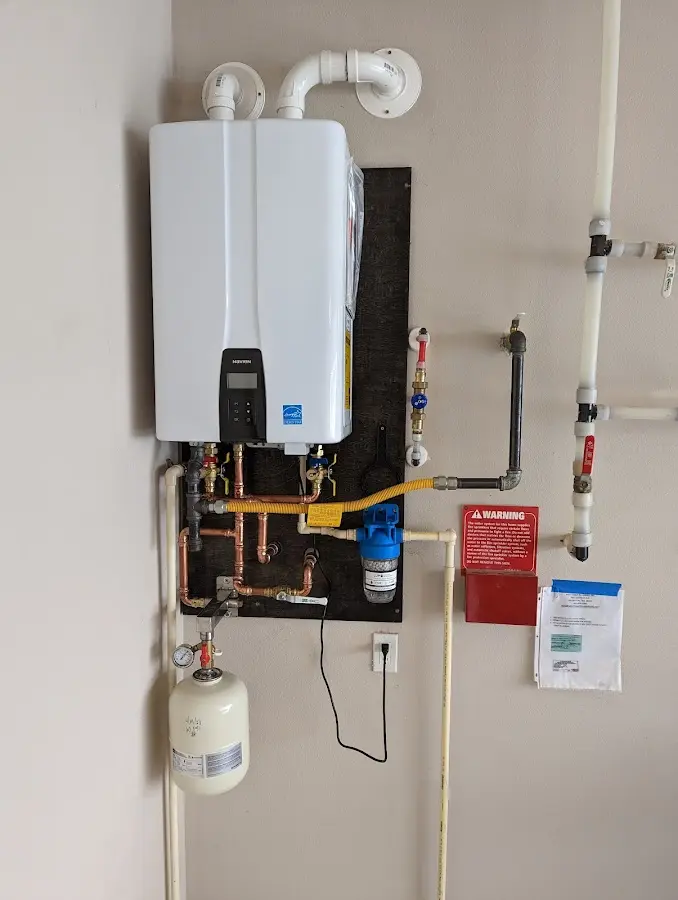 Professional plumber installing copper piping in a San Diego Country Estates home